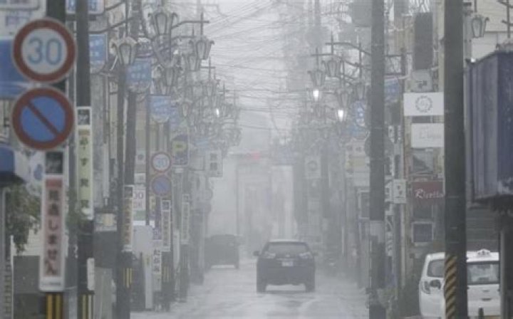 A strong tropical storm lashes parts of Japan and disrupts holiday travel
